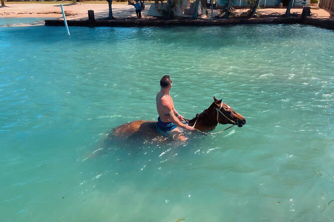 Bamboo Rafting & Horseback Ride n Swim Guided Tour in Montego Bay - Scotchies for jerk chicken and a real meal