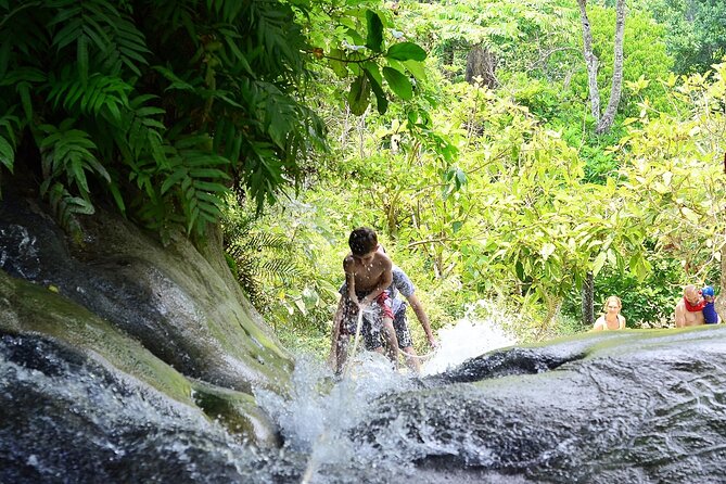 Full Day Chiang Mai Zipline Adventure, Rafting, ATV-ing, and Sticky Waterfall - Climbing and cooling off at Sticky Waterfall