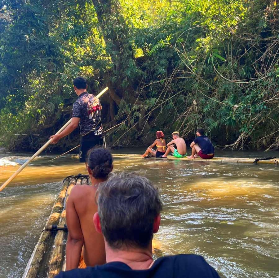 Khao Sok: Private Bamboo Rafting & Jungle Cave Temple Tour - Feeding fish beside the raft