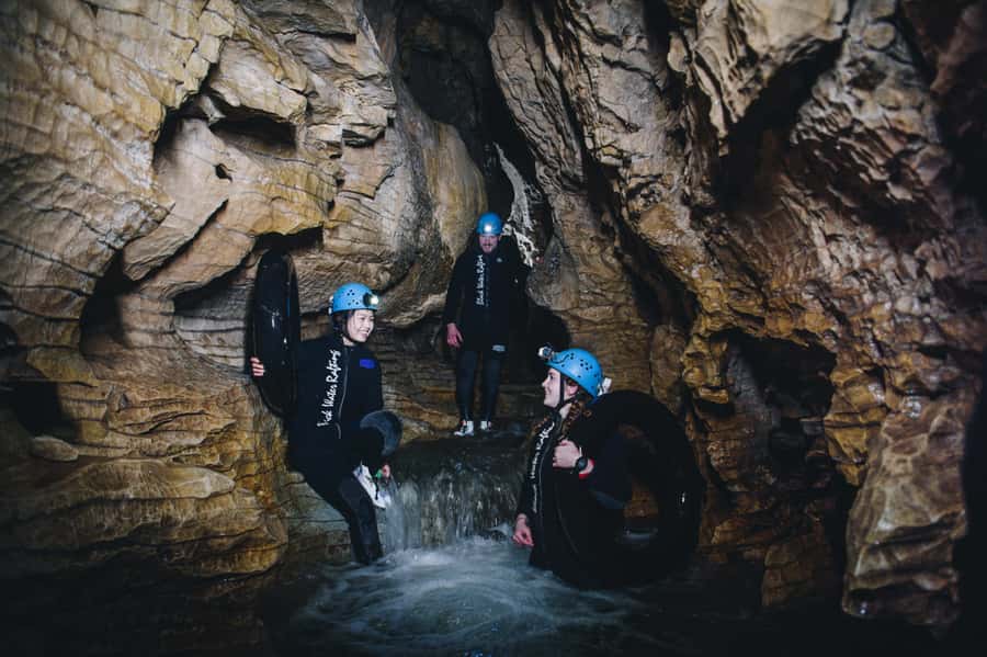 Waitomo Caves: Labyrinth Black Water Rafting Experience - Pulling on a wetsuit and learning the basics